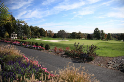 Scenic golf course with colorful floral landscaping.